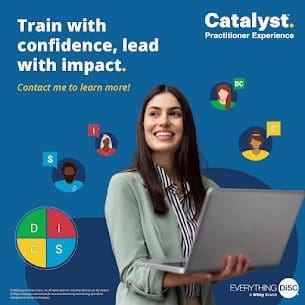 Smiling facilitator holding a laptop, representing confidence in leading DiSC® training sessions